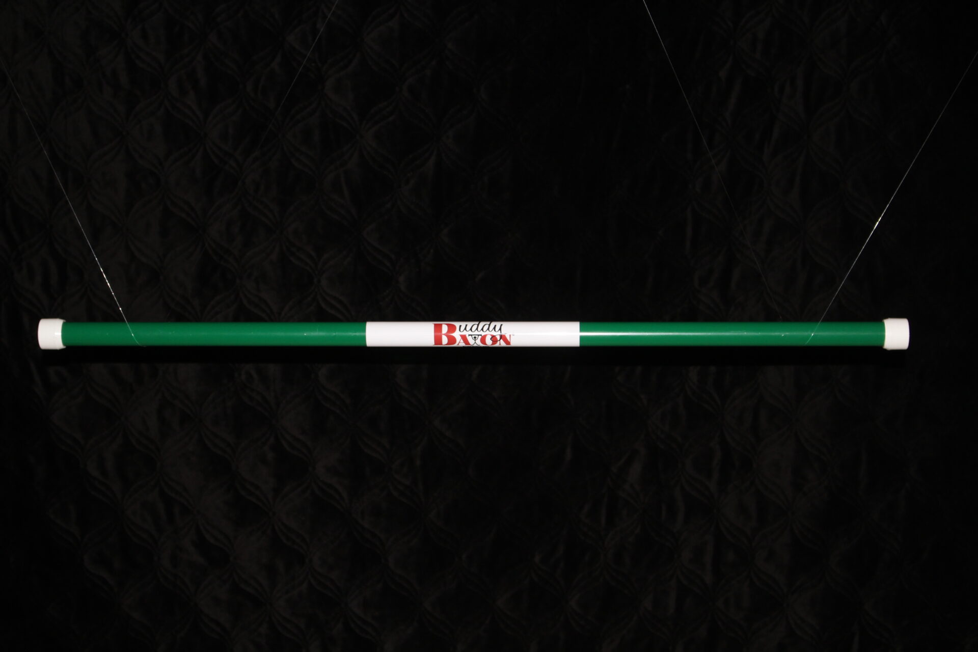 A green stick with red and white writing on it.